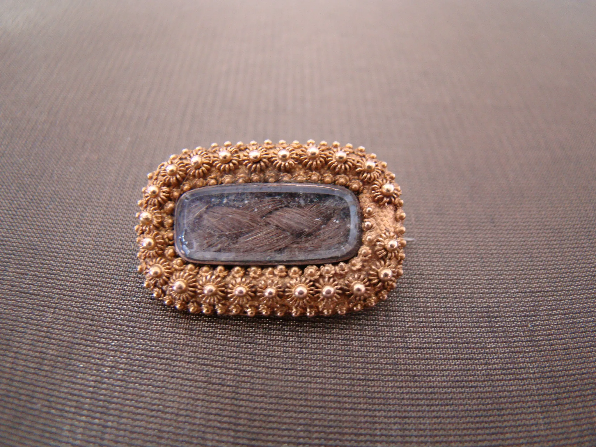 14 kt geel gouden antieke broche met haar achter glas